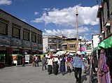 Tibet Lhasa 02 02 Jokhang Barkhor Kora The Barkhor kora is Lhasa�s inner pilgrim circuit, shaped roughly like an octagon running around the Jokhang Temple. We mixed with the pilgrims and, hey, is that a cowboy, and walked clockwise around the circuit, lined with markets, shops, stalls and street vendors providing every conceivable item a Tibetan could need. Behind is a darchen (prayer flagpole), which marks the spot where Tsongkhapa planted his walking stick in 1409.
